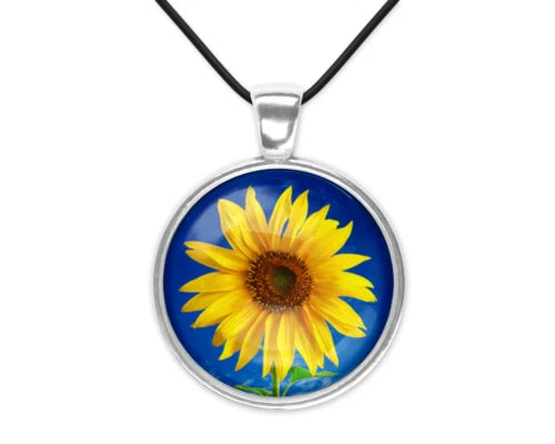 Round sunflower charm pendant necklace with yellow flower in blue glass, on black cord