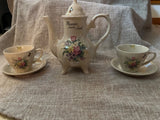 Vintage floral teapot with two cups and saucers, white ceramic set