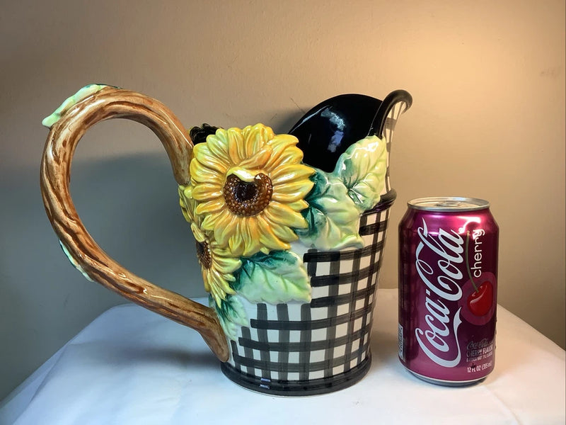 Black gingham ceramic pitcher with large sunflower applique and curved handle