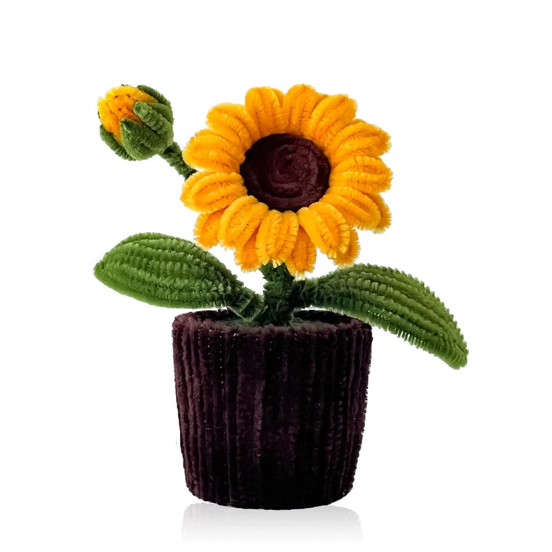 Handmade crochet sunflower on a dark textured pot, yellow petals with green leaves