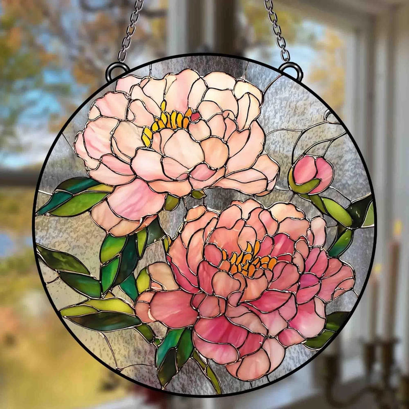 Round peony stained glass suncatcher with pink flowers and green leaves in dark frame