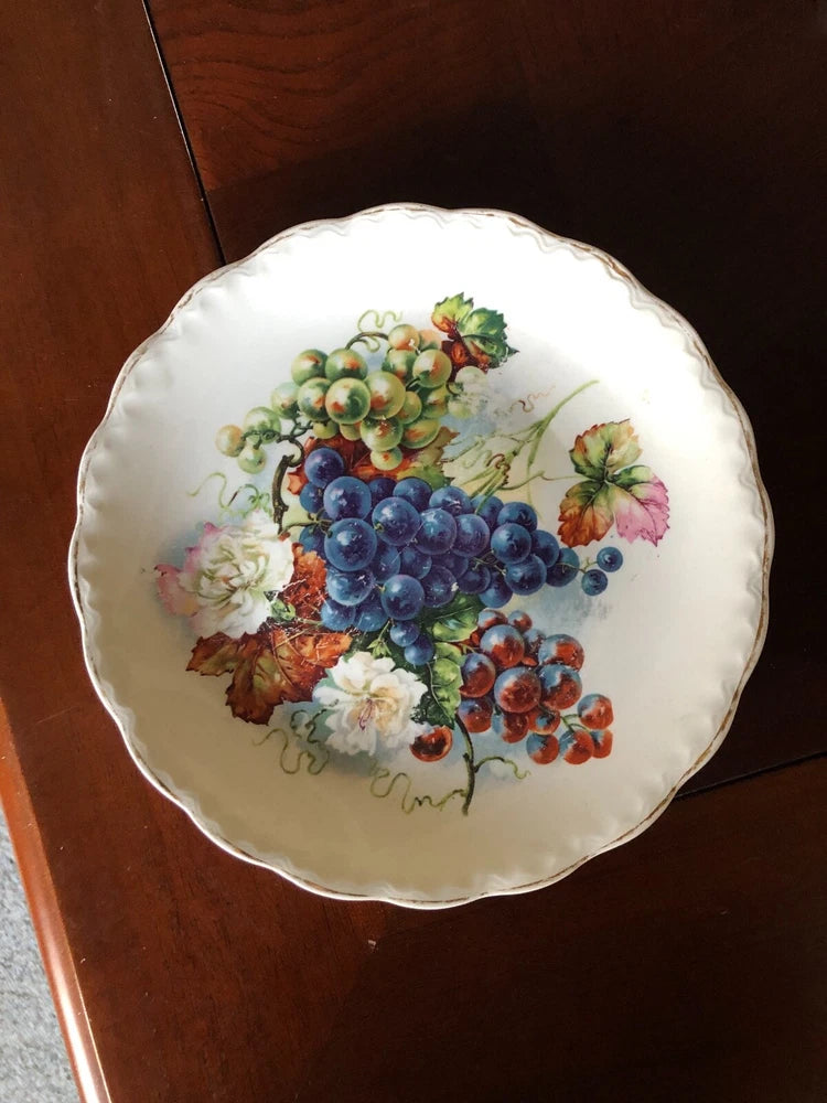 Decorative porcelain fruit plate with grape and berry illustration, scalloped rim