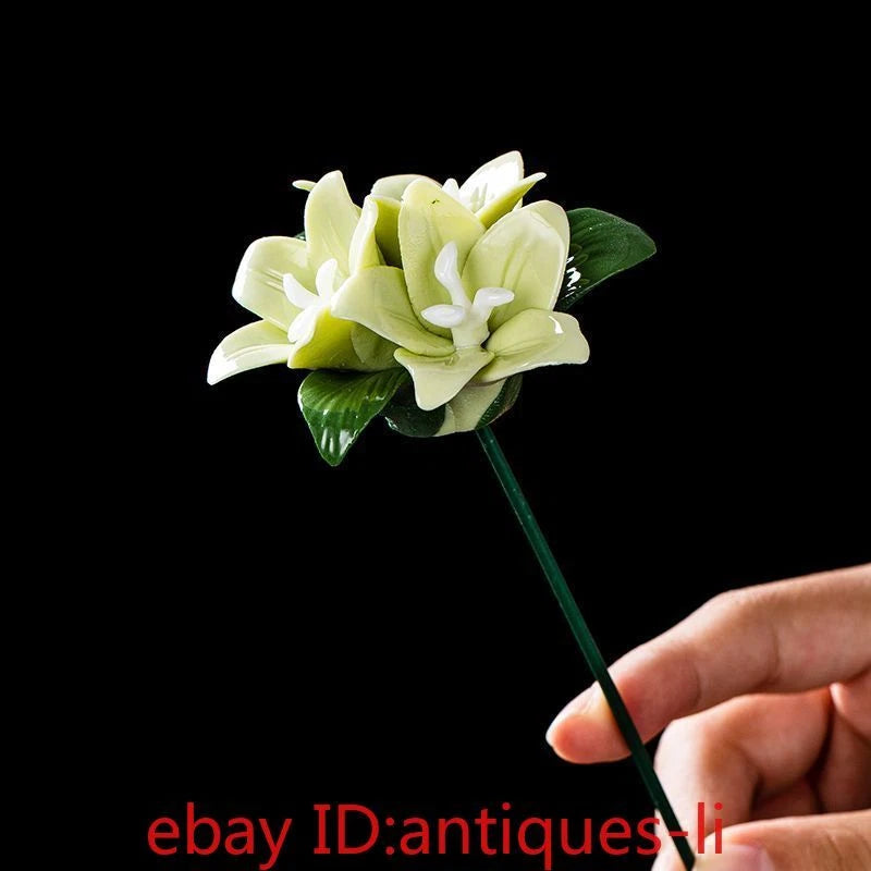 Three-headed ceramic lily flower decoration with pale green and white blooms