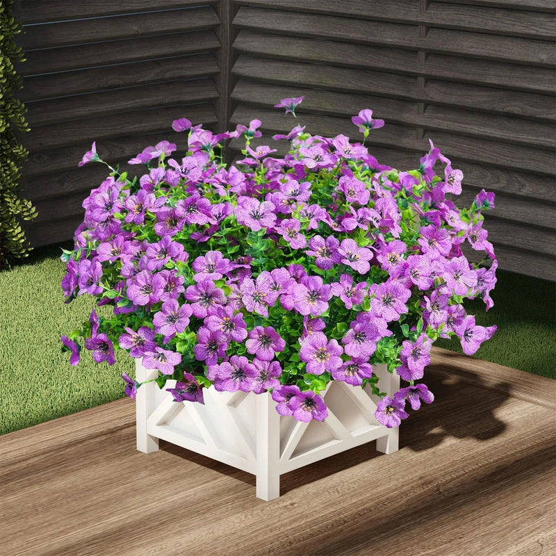 Purple artificial mum-style flowers in a white planter box arrangement