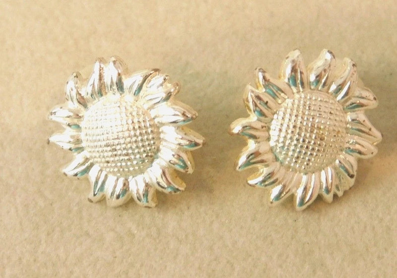 Silver-tone sunflower clip-on button earrings with textured center, round petals.