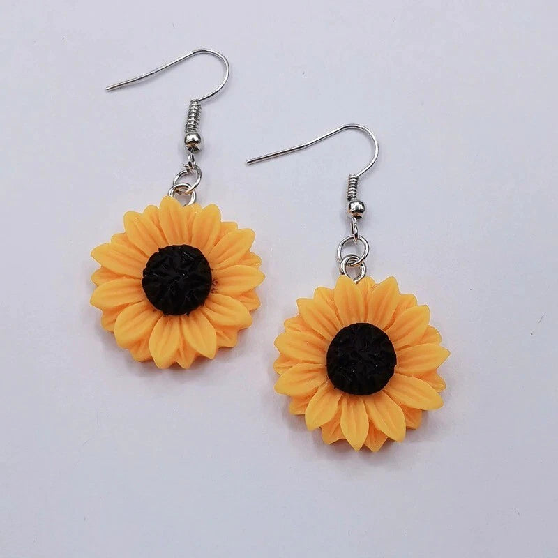 Sunflower drop dangle earrings with silver hooks, orange petals and black centers.