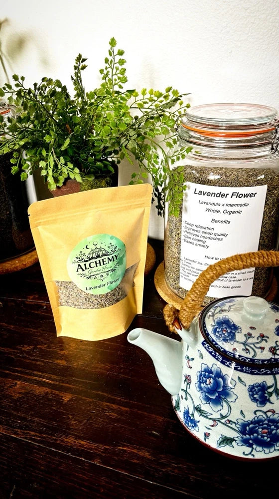 Dried lavender flower buds in yellow Alchemy pouch, beside a glass jar of buds.
