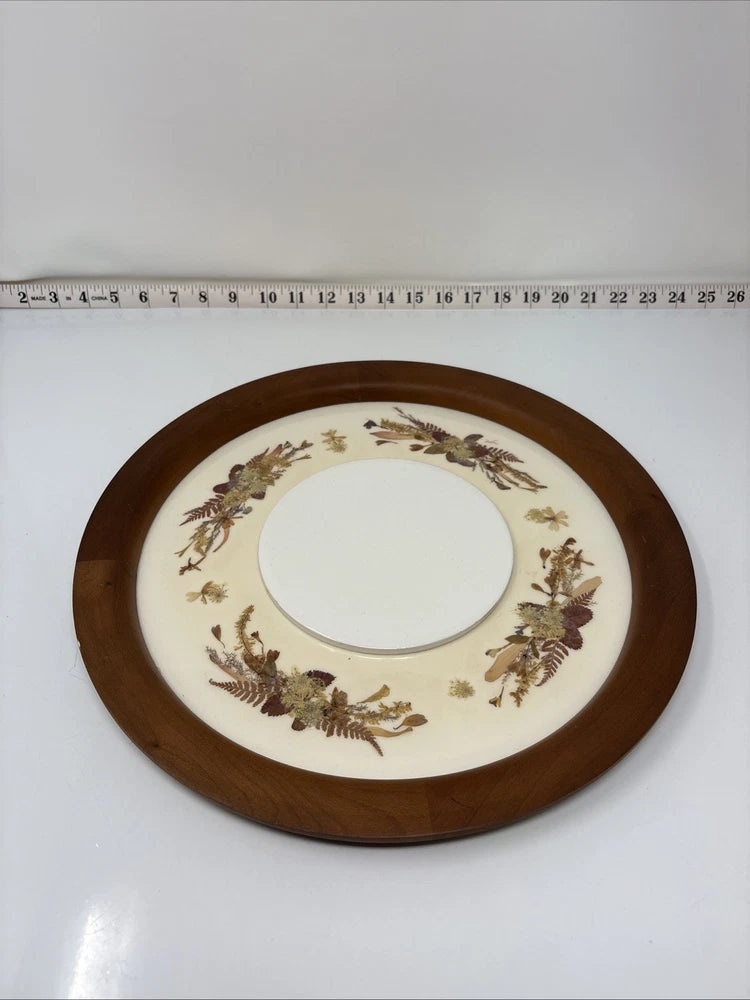 Round dried flower arrangement wreath in dark wooden frame with cream center opening