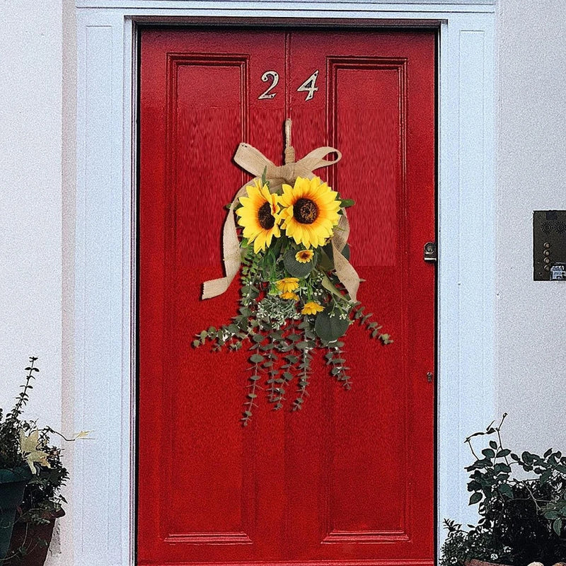 Sunflower hanging swag with yellow flowers, green leaves, and burlap bow