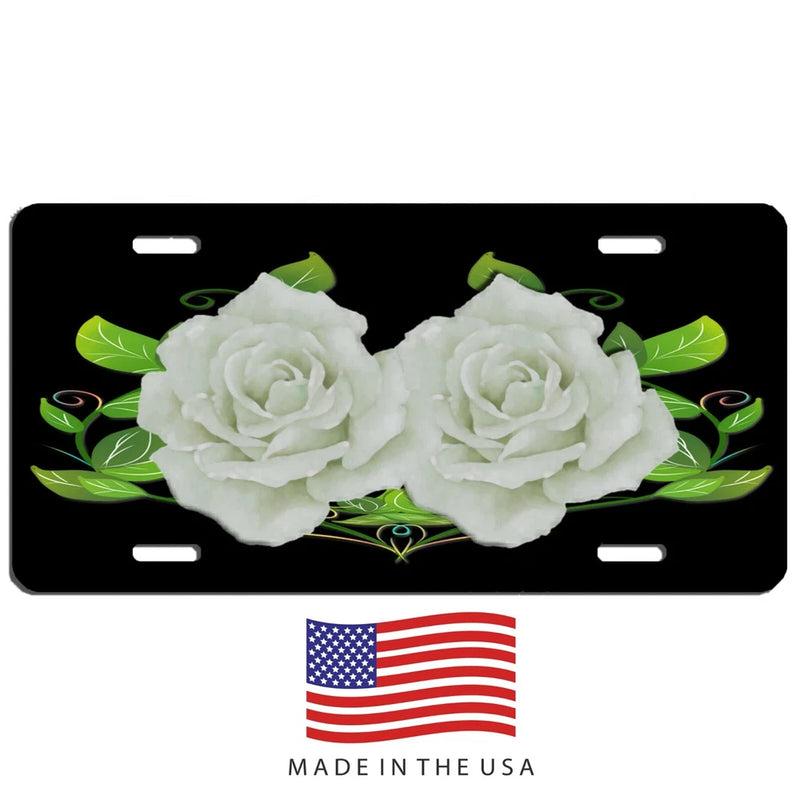 Black aluminum license plate with two white roses, green leaves, and US flag center
