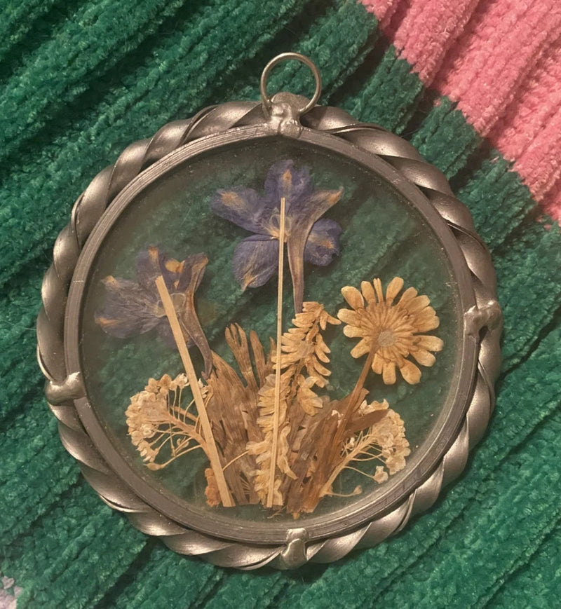 Silver medallion hanging glass frame with pressed dried flowers in clear dome