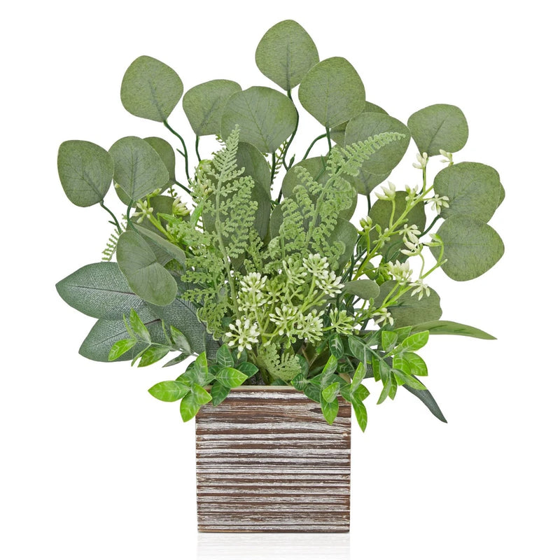 Artificial eucalyptus plant with green fern leaves in rustic striped wooden planter