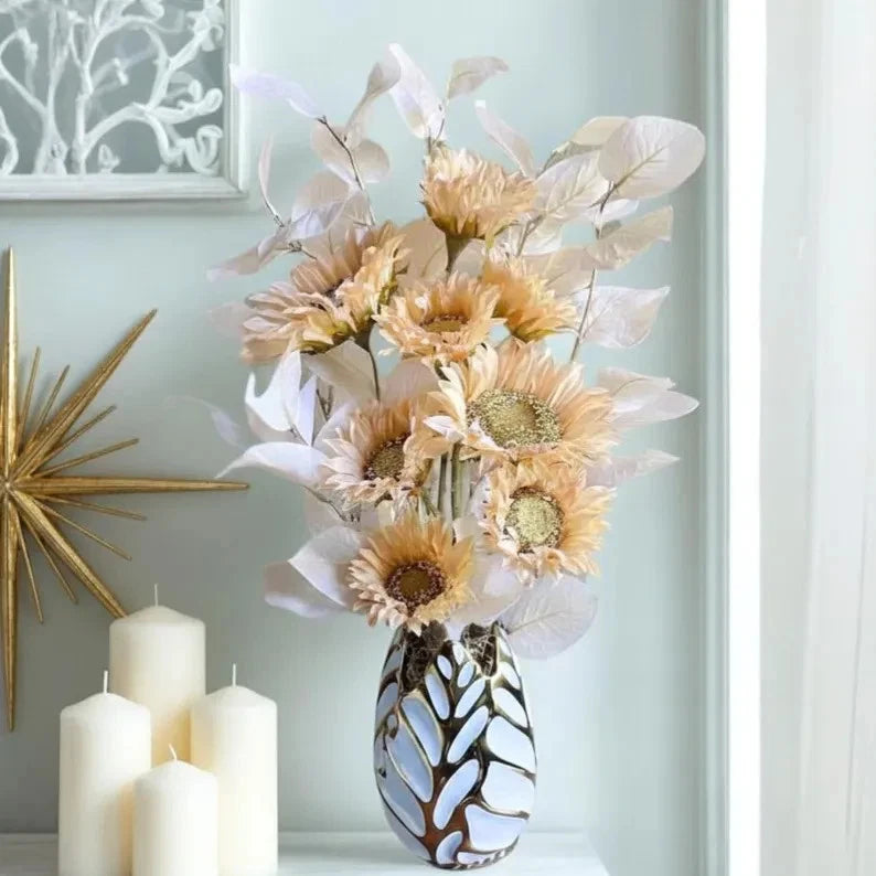 Peach and white sunflower floral arrangement in patterned ceramic vase