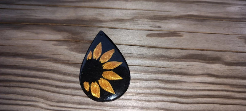 Sunflower resin teardrop pendant, gold and yellow flower on black backing