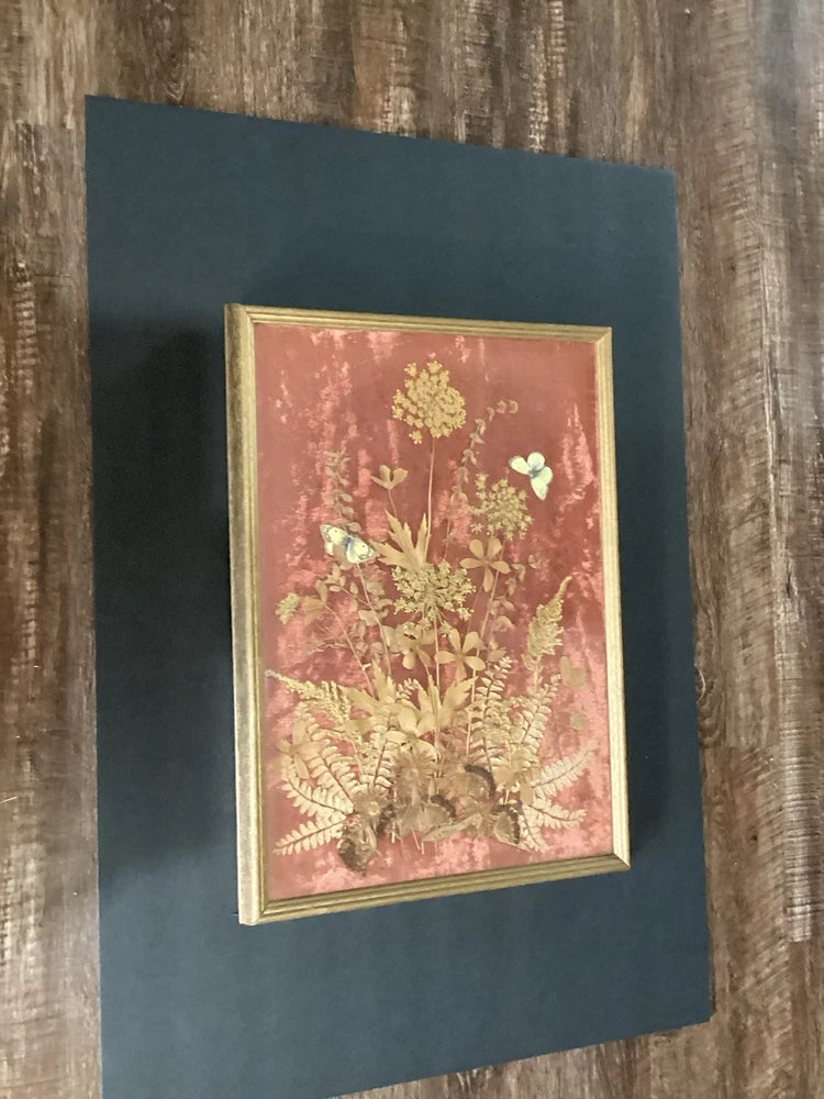 Framed pressed flowers and butterflies wall art in gold mat, light wood frame