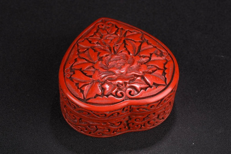 Red carved lacquer jewelry box with peony flower lid and scrolling floral pattern