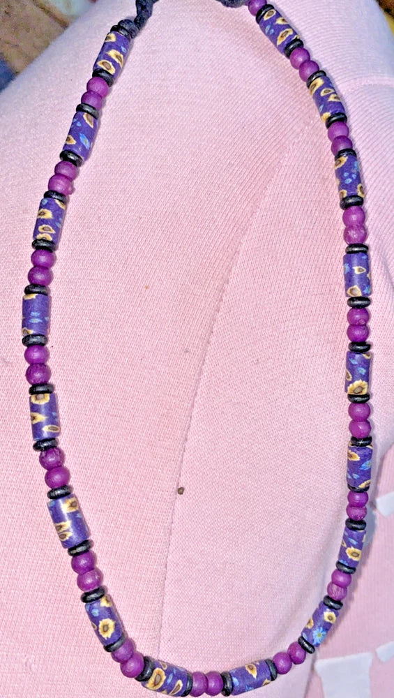Purple beaded necklace with small sunflower and flower motif spacer beads