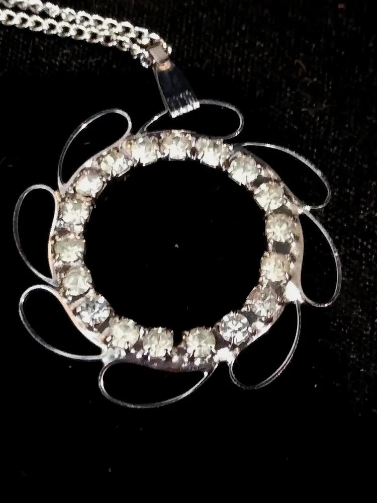 Clear rhinestone sunflower pendant necklace with circular stone halo and silver tone loops