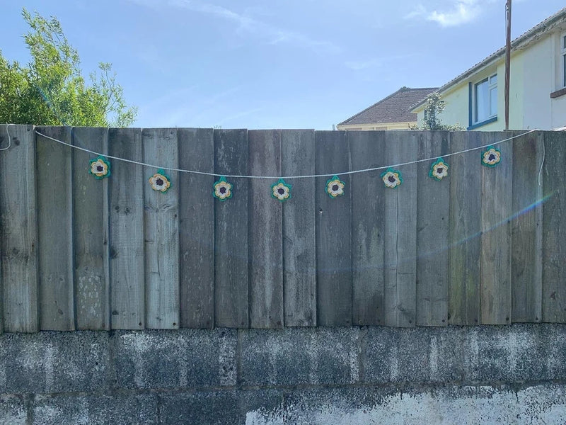 100% cotton handmade sunflower garland with small crocheted blooms along a line