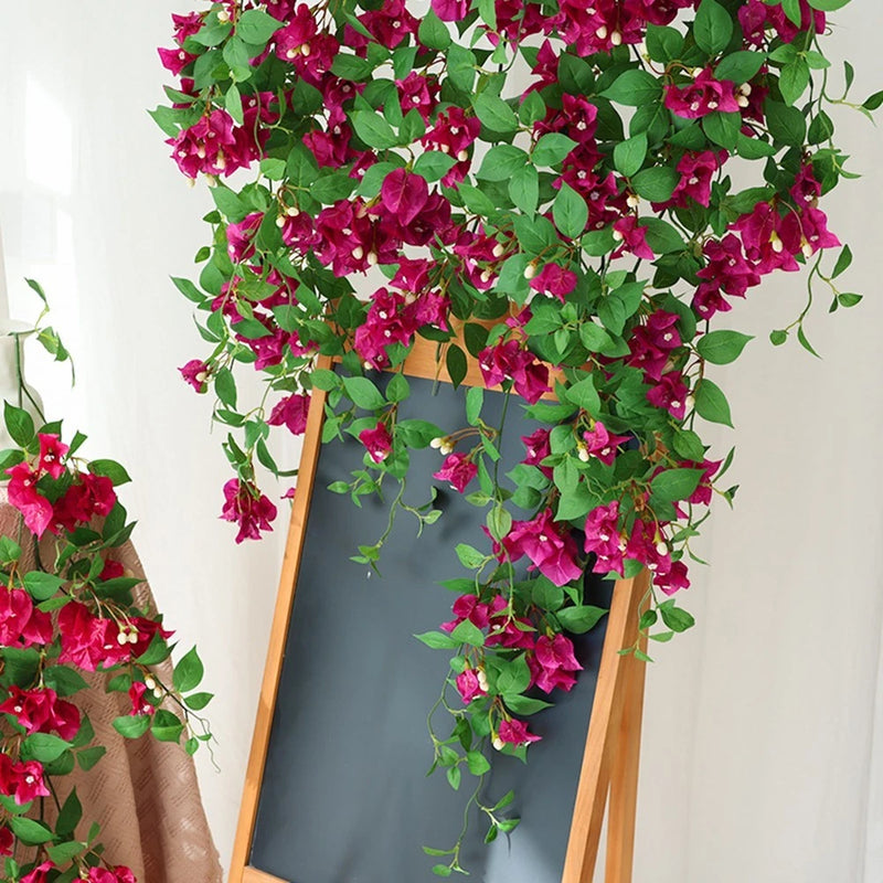 Artificial silk flower vine garland with magenta blooms and green leaves