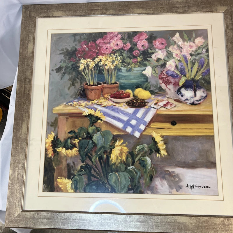 Framed floral still-life artwork with sunflowers and pink blossoms, painted flowers on table