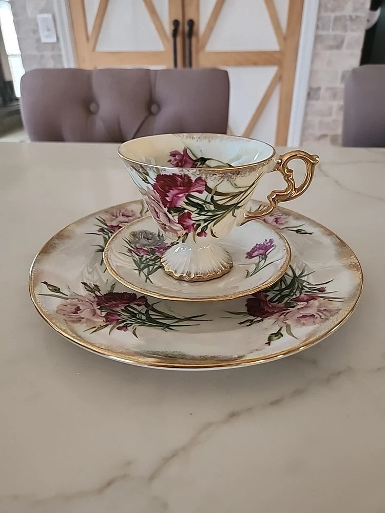 Porcelain floral teacup and saucer set with gold handle and gilded rim