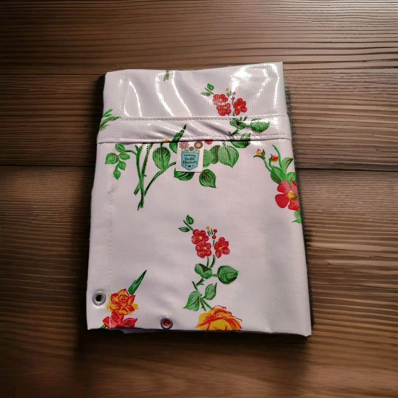 White floral hanging planter pocket with red and orange blossoms and corner grommets