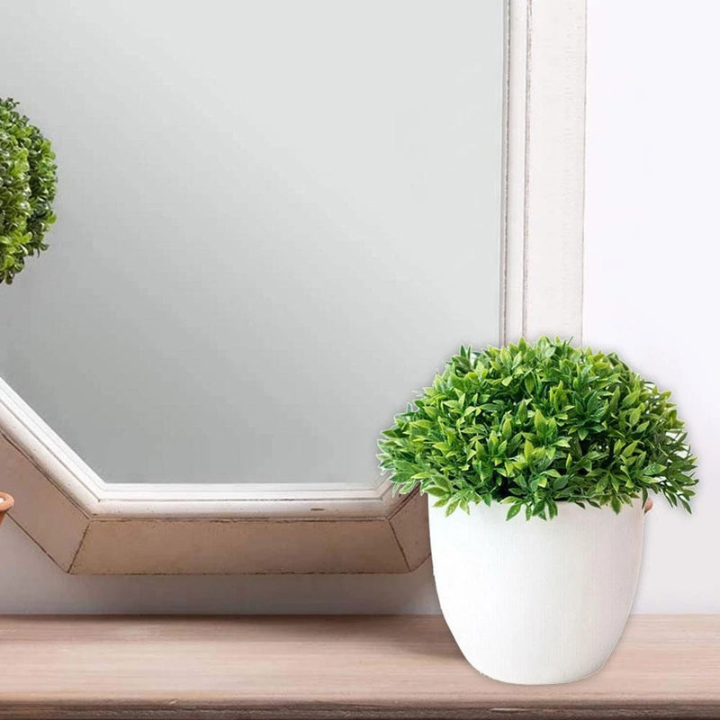 Artificial ball plant in a white pot with dense green leaves for indoor decor