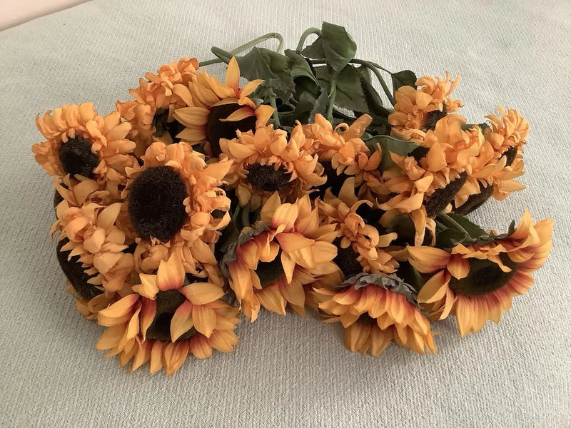 Silk sunflower floral garland with orange blooms and green leaves