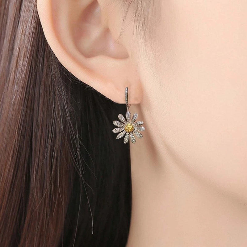 Crystal sunflower hoop earrings with small yellow center and dangling floral charm