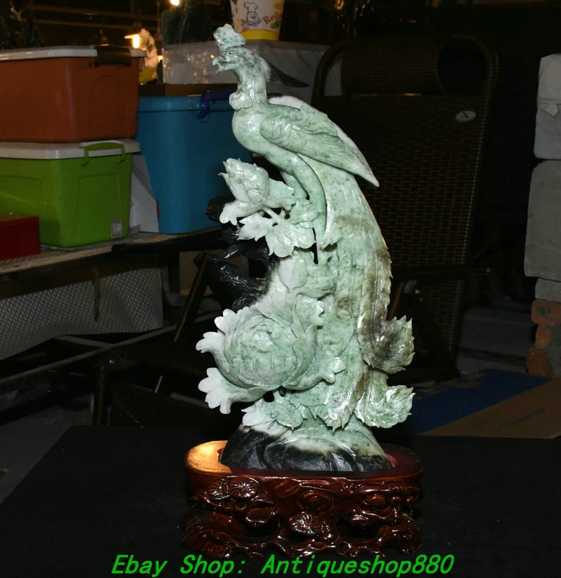 Carved green jade phoenix bird statue with peony blossoms on ornate dark base