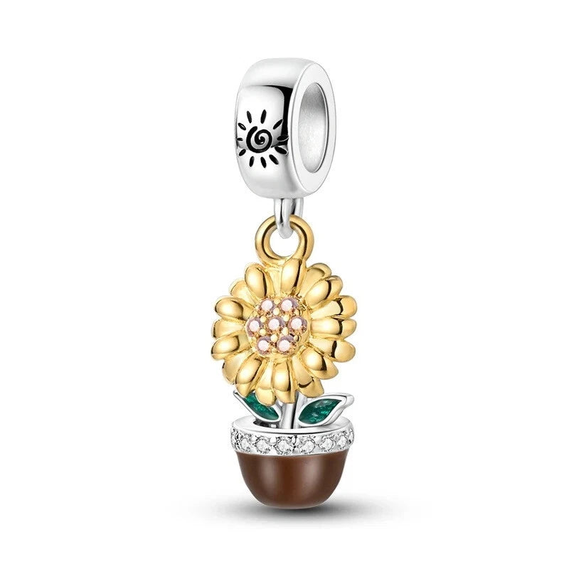 Sterling silver sunflower pot charm with gold flower, purple crystal center, green leaves, brown pot