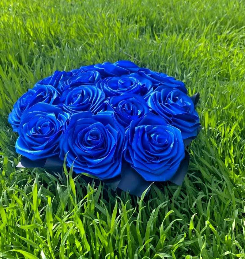 bouquet of blue roses from satin ribbons in a round black box Bouquet