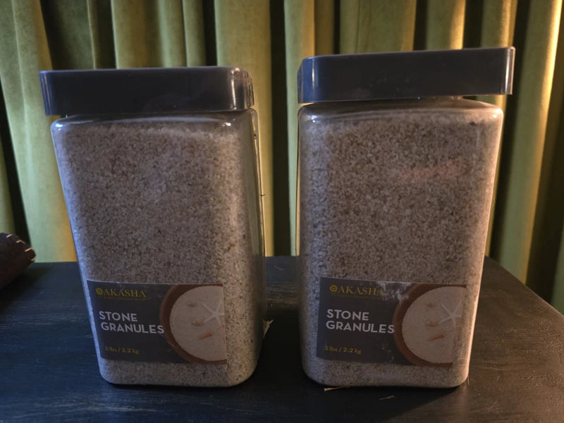 Coarse silica stone granules in clear jars with dark lids