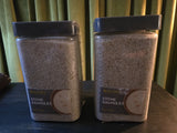 Coarse silica stone granules in clear jars with dark lids