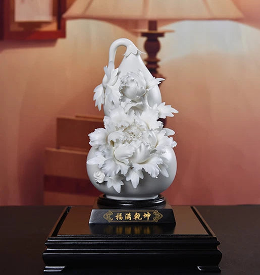 White porcelain gourd vase with carved peony flowers and gold-lettered base