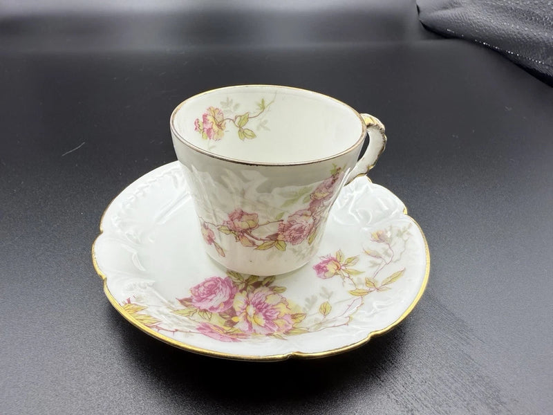 Antique demitasse cup and saucer with pink rose bouquet, gold rim and handle