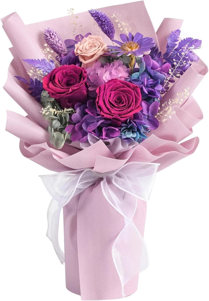 Purple and pink preserved flower bouquet, wrapped in lavender ribbon and sheer bow