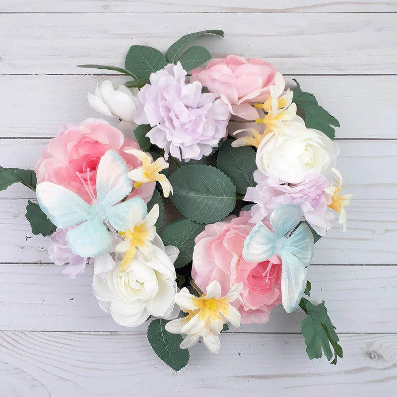 Floral wreath ring with peony-style blooms, butterflies, and green leaves