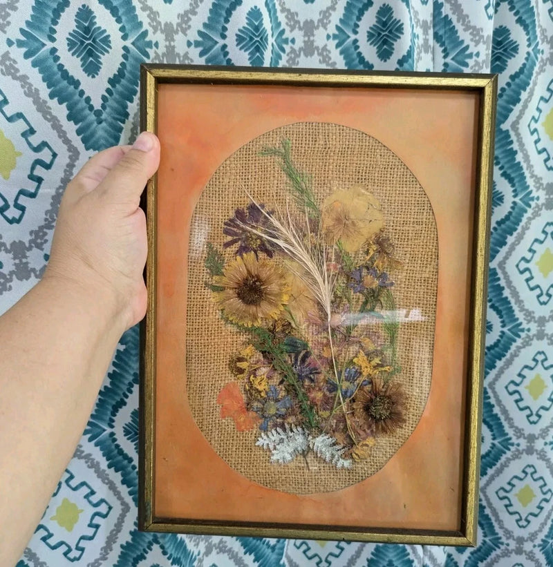 Framed dried flower wall hanging with oval burlap mat and pressed botanicals