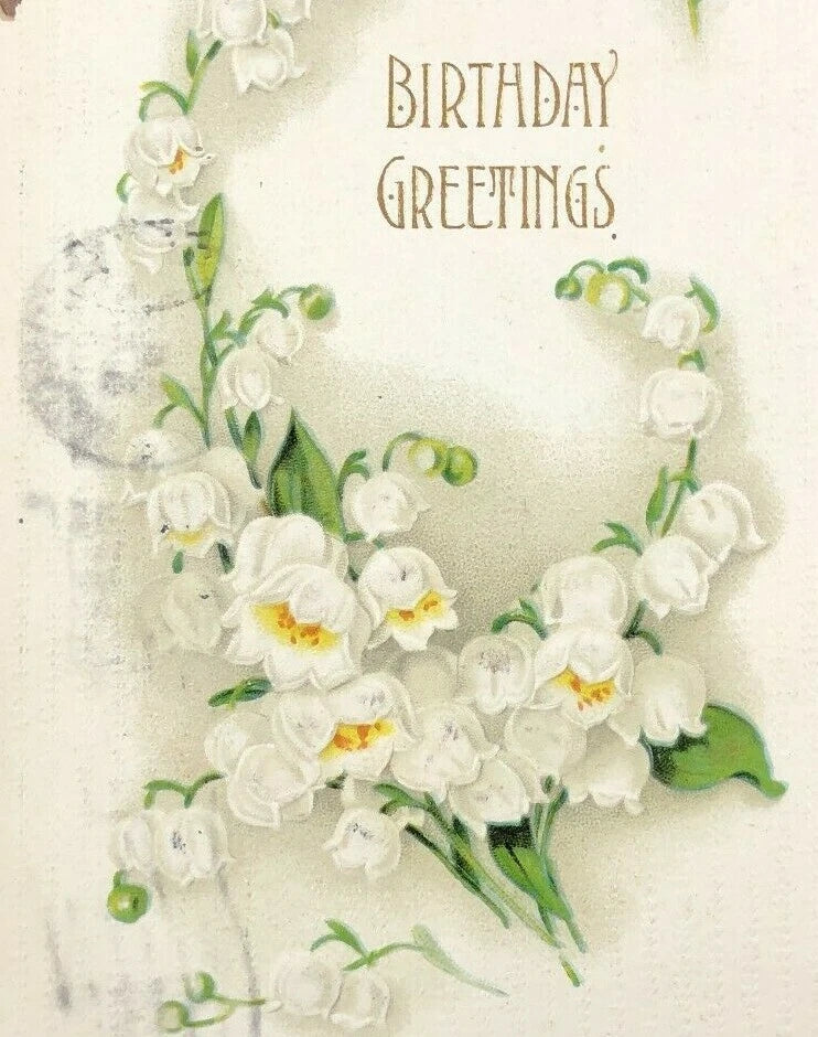 Vintage birthday greetings postcard with white lily of the valley flowers