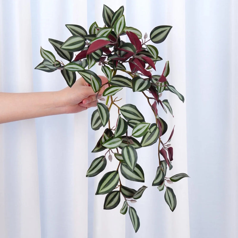 Faux hanging plant with green and burgundy leaves on a trailing vine