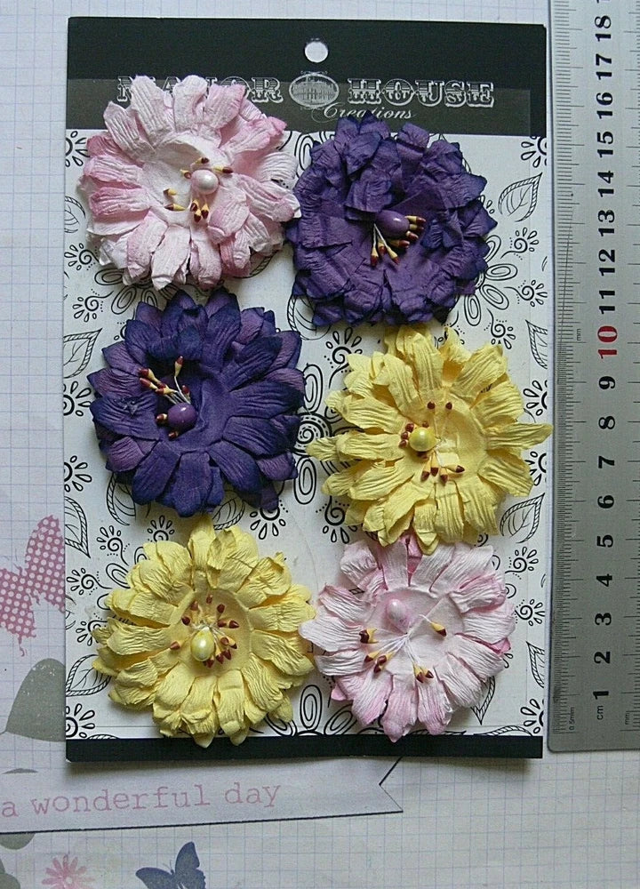 Set of six paper flower embellishments in pink, purple and yellow with gold centers