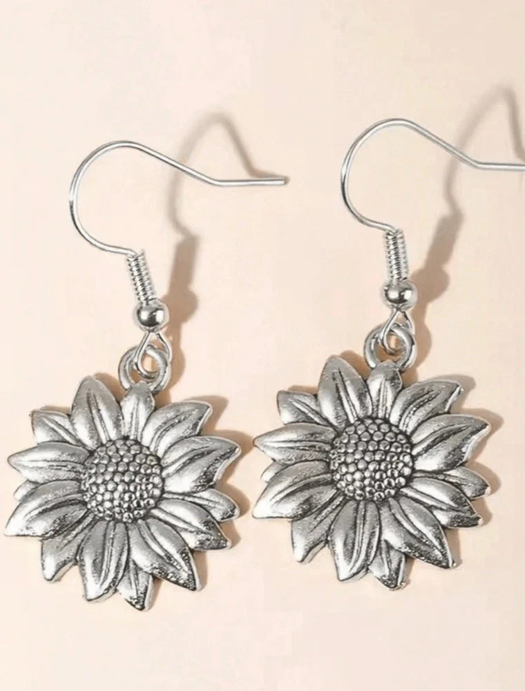 Silver sunflower dangle earrings with textured petals and hooked ear wires