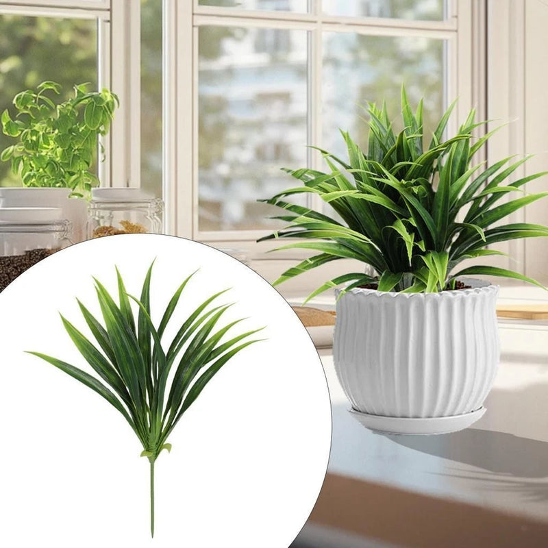 Potted faux greenery plant with spiky green leaves in a white ribbed planter