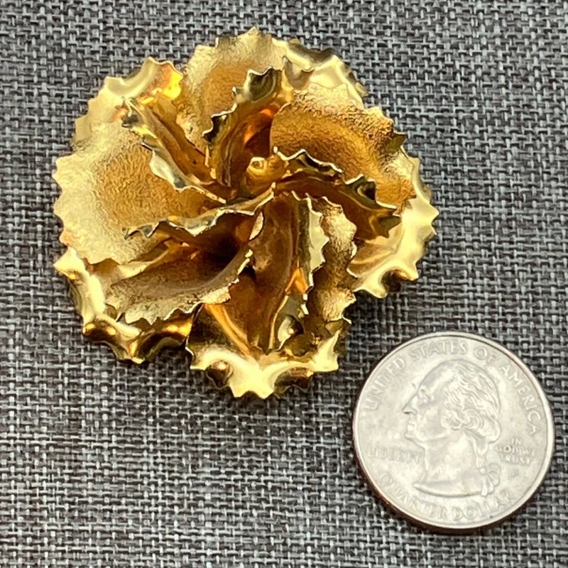 Gold vintage carnation flower brooch pin with textured petals and raised center.
