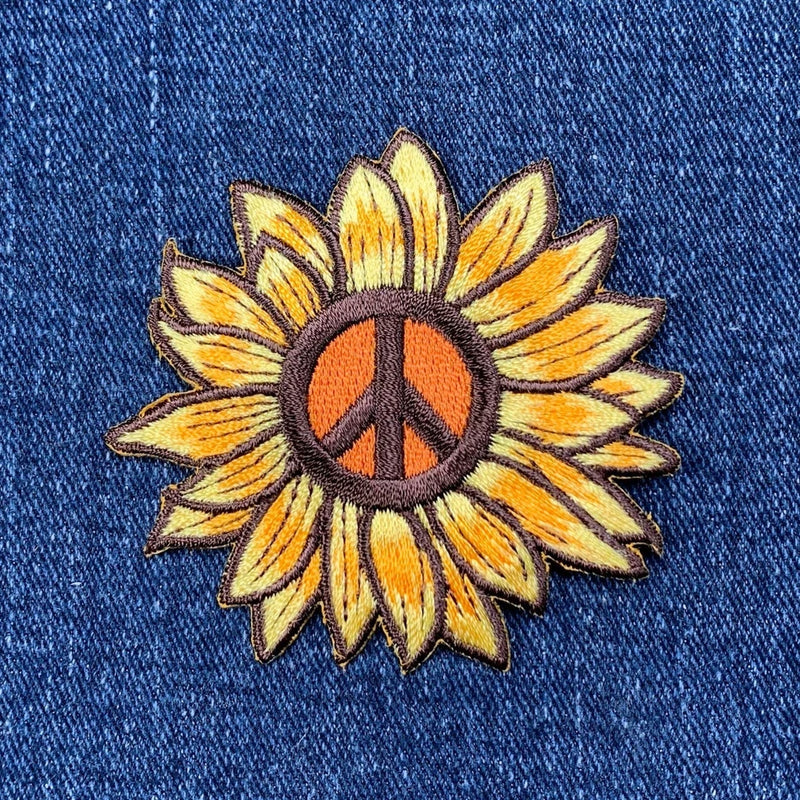 Embroidered sunflower iron-on patch with peace sign center, yellow petals