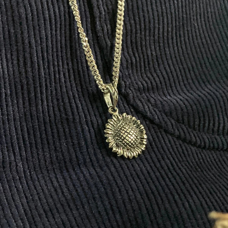Gold-tone sunflower pendant necklace with small round flower charm on chain