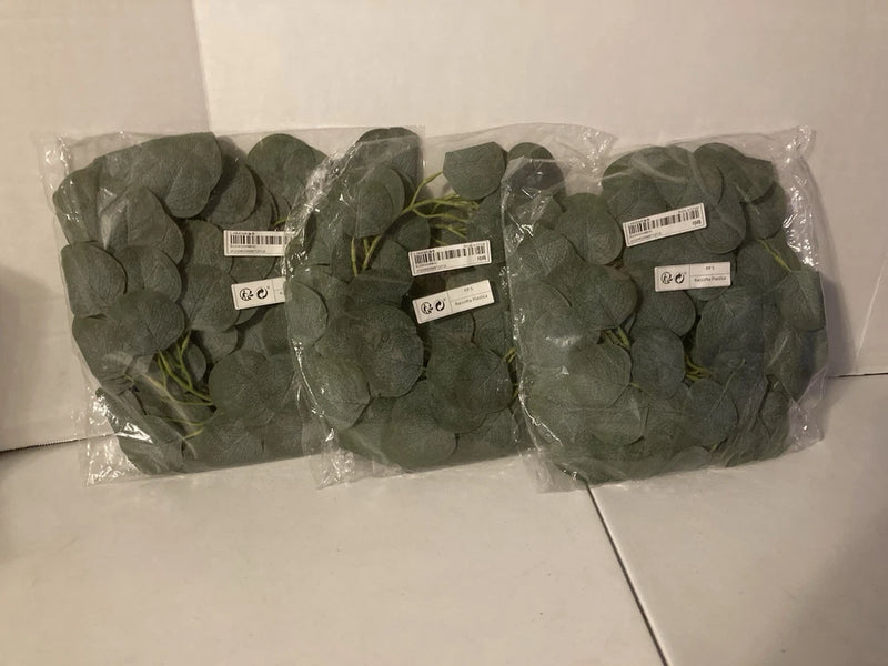 Packaged artificial ivy plant with green leaves and bundled stems