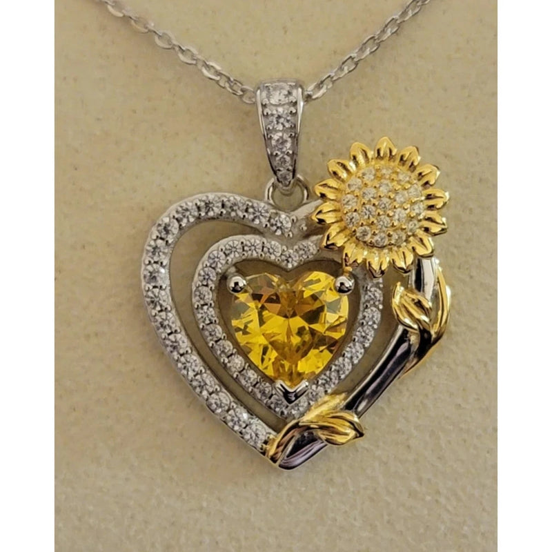 Gold-tone CZ heart pendant necklace with yellow heart center and sunflower detail